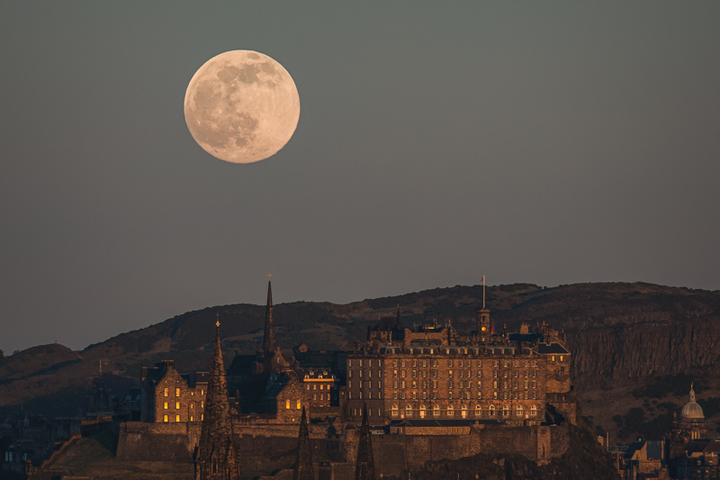A full moon rising above the Edinburgh skyline, warm light on the Georgian buildings below — Raff Karva Photography
