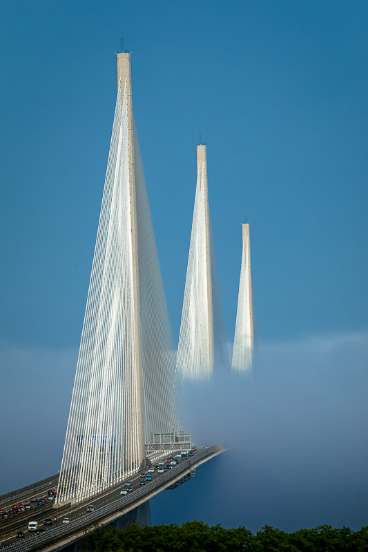 The Queensferry Crossing cable-stay towers rising through morning haar above the Firth of Forth — Raff Karva Photography