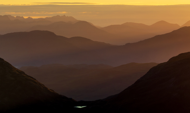 Layered mountain silhouettes receding into a golden sunset sky above Glen Shiel, Kintail — Raff Karva Photography